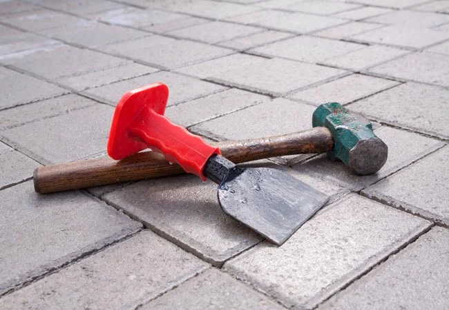 A hammer and a chisel to cut patio pavers