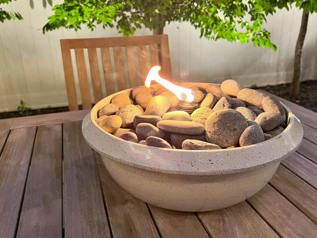 Make a tabletop fire bowl with a clay pot or a glass jar to create a modern and chic look