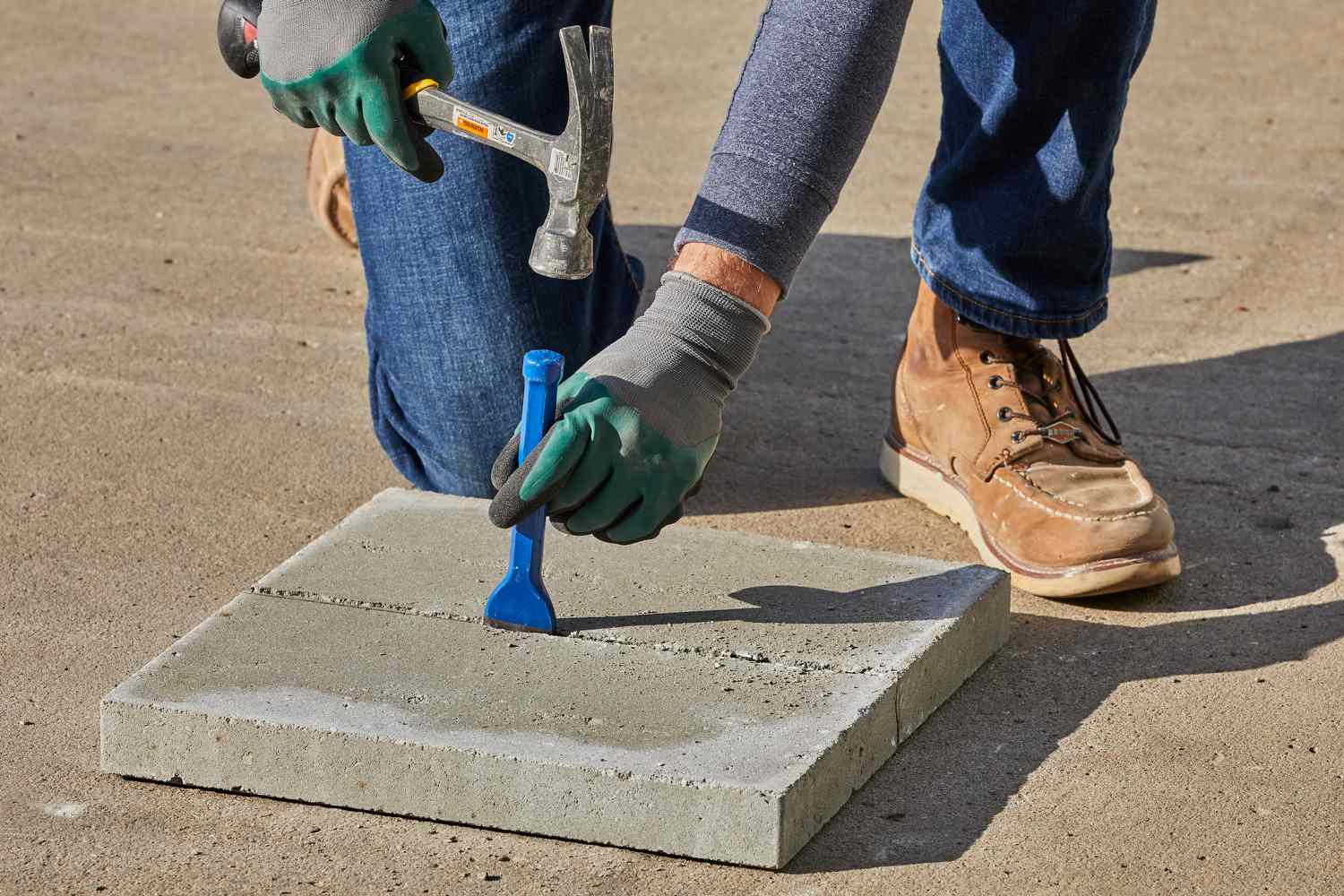 A hammer and a chisel to cut patio pavers