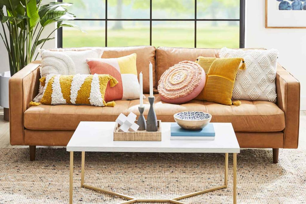Mix and match different sizes, shapes, and textures of cushions and pillows